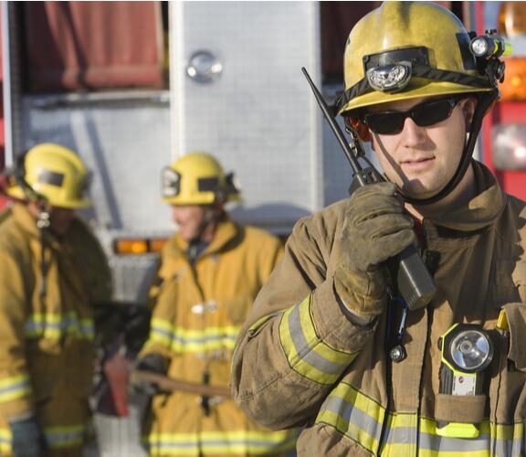 Trained technicians using specialized equipment to measure radio signal strength within a building