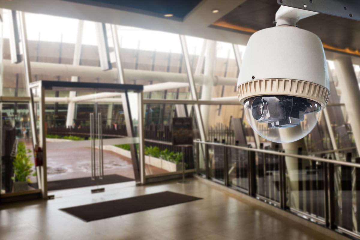 CCTV Camera operating in front of glass door