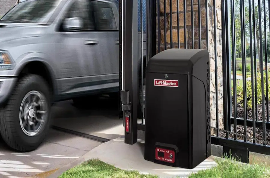 A sliding gate opens to admit entry to a truck.