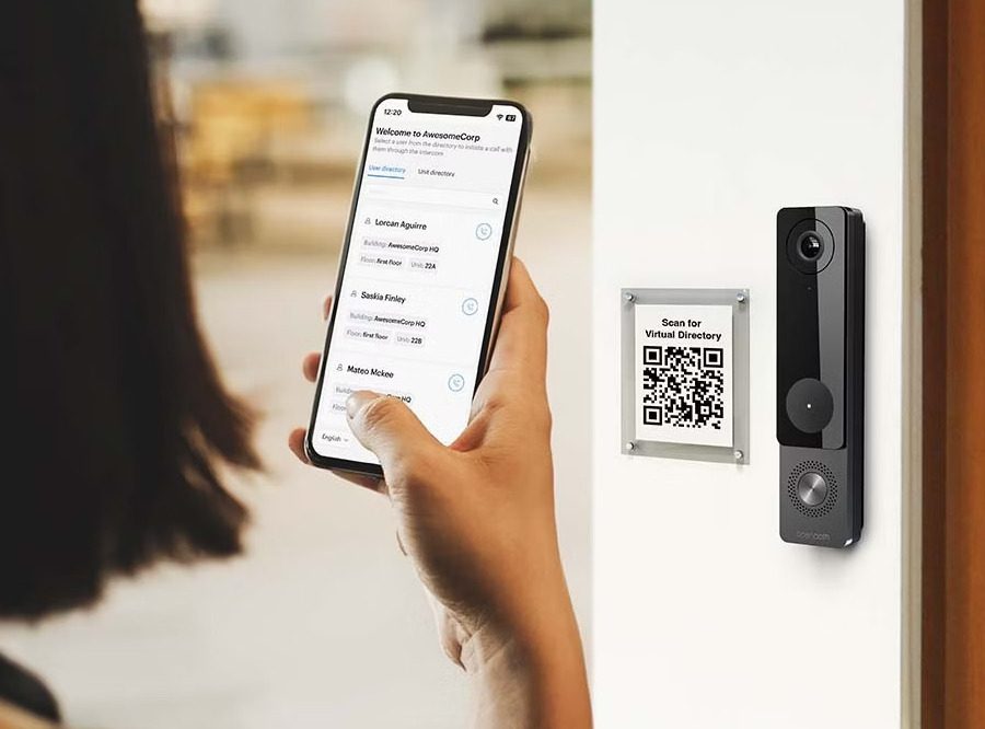 Person using smartphone to access smart video intercom with QR directory for secure entry.