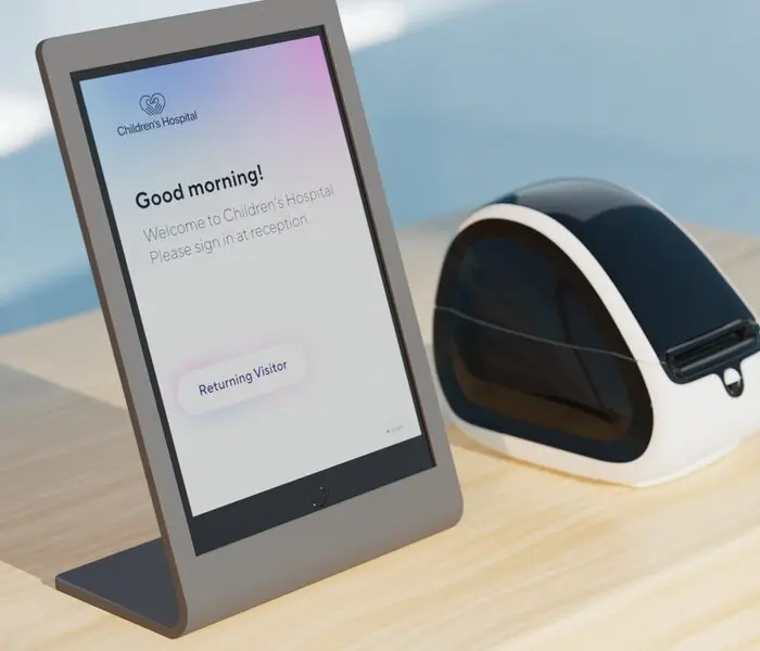 Streamlining Visitor Management for a Safer and More Efficient Workplace Person in a suit holding a blue access card near a contactless reader at a secure entry gate.